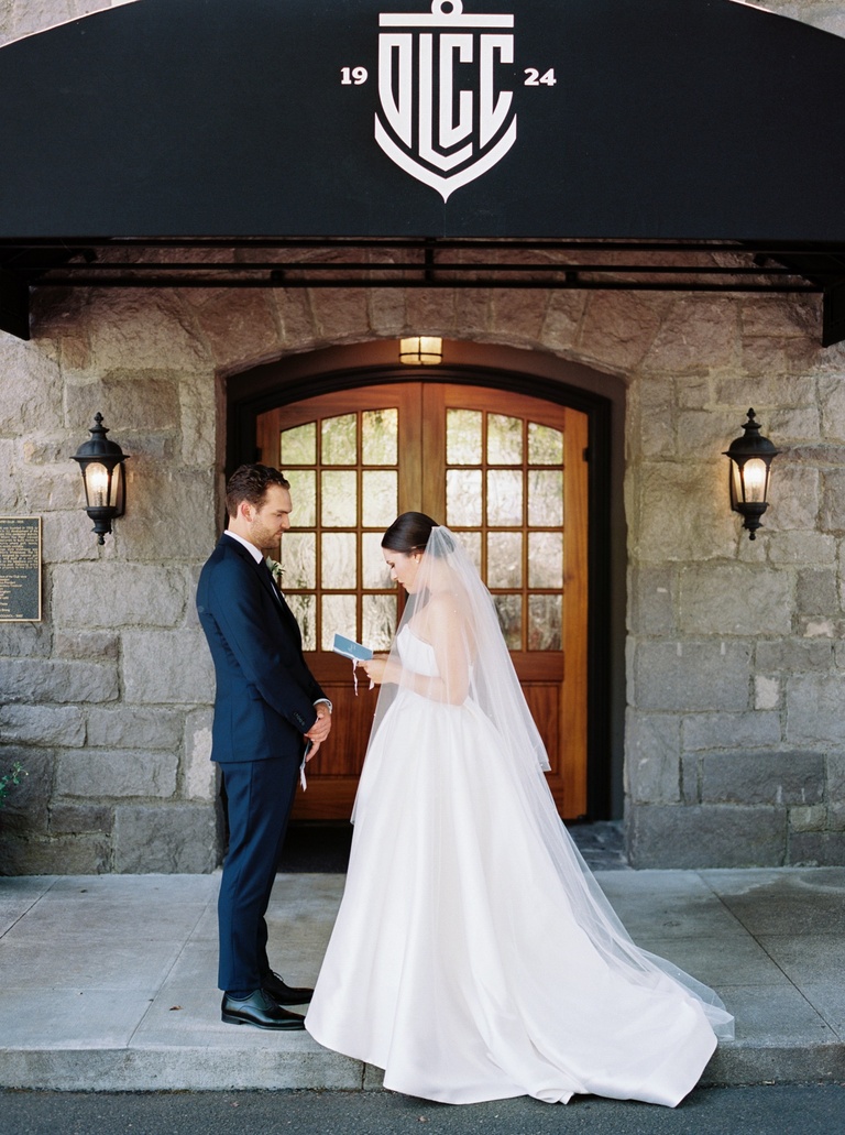Bride and groom reading private vows before their wedding ceremony