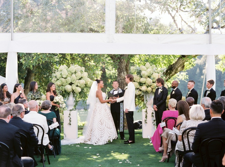 Outdoor wedding ceremony under a clear-top tent at Waverly Country Club