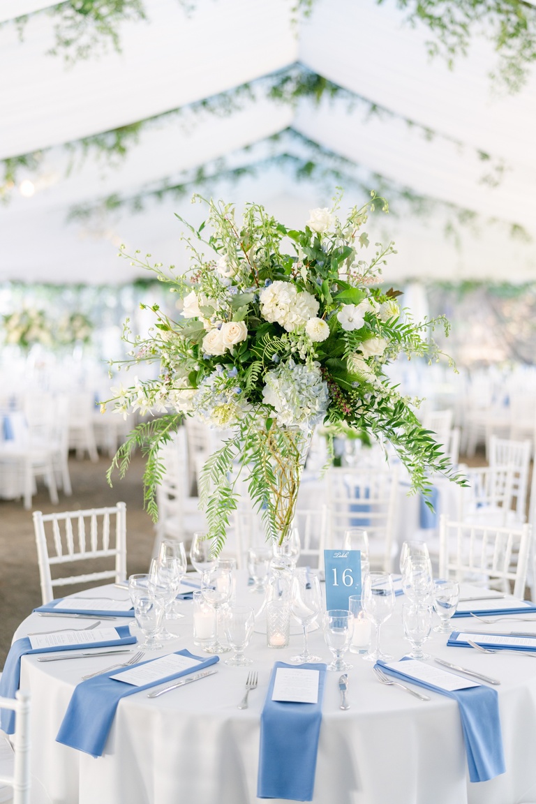 Tall floral centerpiece with white hydrangeas and delphinium
